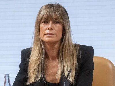 A court in Madrid has ordered the wife of Spain's prime minister to surrender her passport and attend court hearings