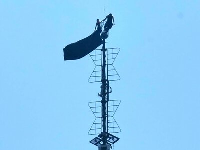 Two people climbed the Empire State Building antenna and unfurled a banner about the power of love; after descending, they were arrested