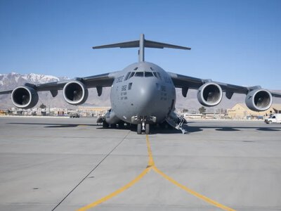 Why did the CIA director fly to Moscow on a C-17 capable of carrying 77 tons?
