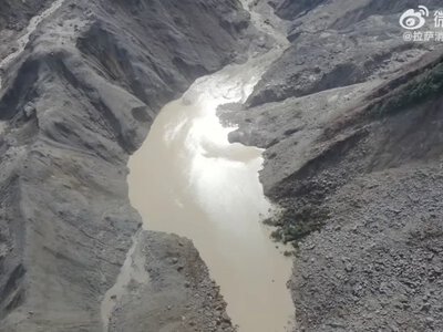 The risk of a lake breach near the China–Nepal border has decreased after a massive flood