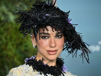 Dua Lipa's Updo Fits Perfectly Under Her Chanel Statement Hat